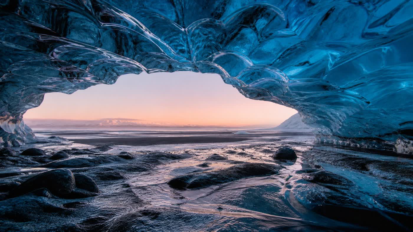 Blue ice cave opening onto a pale sunset, an AI-generated sample